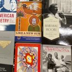 Various books about poetry sitting on a table.
