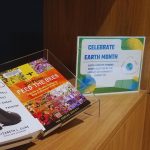 Sustainability-themed books on display on a bookshelf.